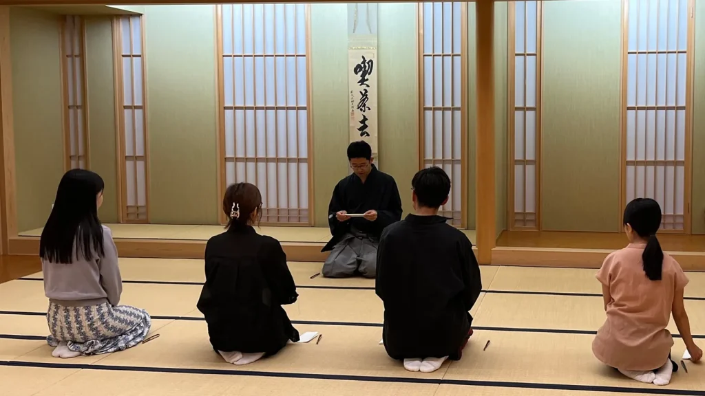 としま区民センターの和室で、講師と向かい合って座る喫茶去の参加者